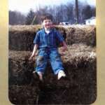 Gary sitting on straw bales